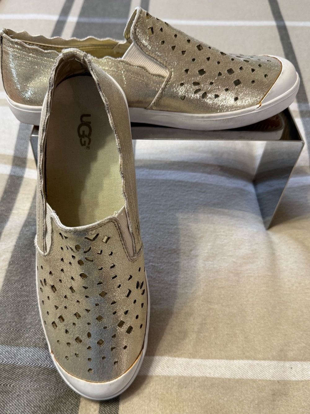 UGG, gold metallic slip on sneakers. Available in a size 6.